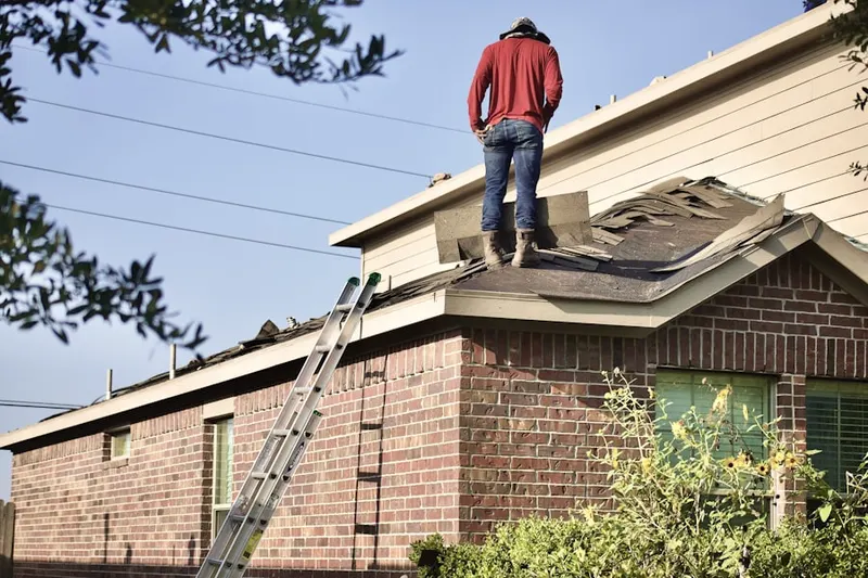 Professional roofer working on a residential roof in Bethel Grove